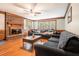 Cozy living room with a brick fireplace, hardwood floors, and ample natural light at 3392 Inns Brook Way, Snellville, GA 30039
