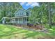 Well-manicured yard with mature landscaping highlighting this lovely home and its porch at 3392 Inns Brook Way, Snellville, GA 30039