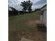 Expansive backyard with a shed, table, and sloped grassy terrain at 380 South St, Buford, GA 30518