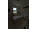Bathroom with tiled garden tub, tile flooring, window to the outdoors, and pedestal sink at 380 South St, Buford, GA 30518