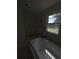 Bathroom with window, garden tub, mirror, and partial view of sink at 380 South St, Buford, GA 30518