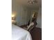 Bedroom showcasing a rocker, access to kitchen, overhead lighting and a side table with lamp at 380 South St, Buford, GA 30518