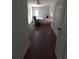 Bright bedroom featuring a queen-size bed, rocker, white door to outside, and hardwood floors at 380 South St, Buford, GA 30518