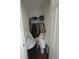 Small closet with hanging clothes and some items stored on the floor at 380 South St, Buford, GA 30518