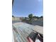 Outdoor deck featuring wood planks, table, and partially obscured backyard views at 380 South St, Buford, GA 30518