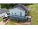 Back exterior view of home with a small deck and a truck parked next to the structure at 380 South St, Buford, GA 30518