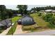 Cozy home with a deck, a large lawn, mature trees, and a unique carport underneath the rear of the house at 380 South St, Buford, GA 30518