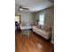 Bright living room boasts hardwood floors, ceiling fan and comfortable seating at 380 South St, Buford, GA 30518