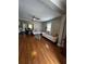 Spacious living room with hardwood floors, neutral paint, a ceiling fan, and an open floorplan at 380 South St, Buford, GA 30518
