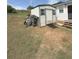 Outdoor shed with a table and a wheelbarrow on a grassy lot at 380 South St, Buford, GA 30518