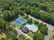 A lush landscape with a community pool, tennis courts, and clubhouse provides abundant recreational opportunities at 858 Red Rock Ct, Suwanee, GA 30024