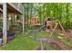Spacious backyard offers a wooden playset and lush landscaping at 858 Red Rock Ct, Suwanee, GA 30024