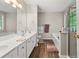 Spacious bathroom boasts double sinks, soaking tub, and stylish tile accents at 858 Red Rock Ct, Suwanee, GA 30024