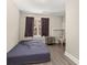 Bedroom with hardwood floors, and natural light from the window with dark curtains at 858 Red Rock Ct, Suwanee, GA 30024