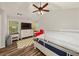 Inviting bedroom features wood floors, ceiling fan, and lots of natural light at 858 Red Rock Ct, Suwanee, GA 30024
