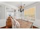 Bright dining area with hardwood floors, stylish chandelier, and adjacent study at 858 Red Rock Ct, Suwanee, GA 30024