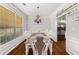 Elegant dining room with hardwood floors, chandelier, and a view into the kitchen at 858 Red Rock Ct, Suwanee, GA 30024