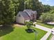 Aerial shot of a beautifully landscaped property with lush greenery and a well-manicured lawn at 858 Red Rock Ct, Suwanee, GA 30024