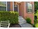 Close-up of the front porch featuring brick facade, concrete steps, and an inviting entry at 858 Red Rock Ct, Suwanee, GA 30024