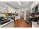 Well-lit kitchen features stainless steel appliances, white cabinets, and hardwood floors at 858 Red Rock Ct, Suwanee, GA 30024
