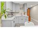 Modern kitchen featuring gray cabinetry, sleek countertops, and updated appliances at 858 Red Rock Ct, Suwanee, GA 30024