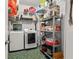 Efficient laundry room with washer, dryer, shelving, and organized storage at 858 Red Rock Ct, Suwanee, GA 30024