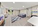 Bright living room featuring recessed lighting, gray sofa, and modern flooring at 858 Red Rock Ct, Suwanee, GA 30024