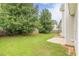 A home featuring a spacious backyard with a lush lawn and mature trees at 330 Kentwood Springs Dr, Hampton, GA 30228