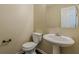 Powder room with pedestal sink, wood trim, and modern fixtures at 330 Kentwood Springs Dr, Hampton, GA 30228