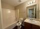 Bright bathroom featuring a shower-tub combo, toilet, and vanity with sink at 330 Kentwood Springs Dr, Hampton, GA 30228