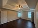 Spacious bedroom features tray ceiling, large windows, hardwood flooring, and neutral paint at 330 Kentwood Springs Dr, Hampton, GA 30228