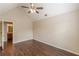 Spacious bedroom featuring wood-look floors, a ceiling fan, and a view to an adjoining bathroom at 330 Kentwood Springs Dr, Hampton, GA 30228