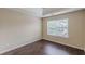 A bright bedroom with a trey ceiling, hardwood floors and a sunlit window at 330 Kentwood Springs Dr, Hampton, GA 30228