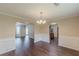 Elegant dining room with wainscoting, hardwood floors, and access to the kitchen at 330 Kentwood Springs Dr, Hampton, GA 30228