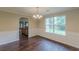 Dining room with hardwood floors and wainscotting details, illuminated by a chandelier at 330 Kentwood Springs Dr, Hampton, GA 30228