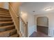 Carpeted stairs lead to the home's upper level with open access to the home's interior at 330 Kentwood Springs Dr, Hampton, GA 30228