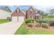 Charming two-story brick home with a well-manicured lawn and attached two-car garage at 330 Kentwood Springs Dr, Hampton, GA 30228