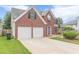 Attractive brick home featuring a two-car garage and classic window shutters at 330 Kentwood Springs Dr, Hampton, GA 30228