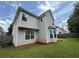 Home exterior featuring beige siding and large windows overlooking the backyard at 330 Kentwood Springs Dr, Hampton, GA 30228