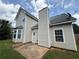 Exterior view of the home with beige siding and a concrete patio at 330 Kentwood Springs Dr, Hampton, GA 30228