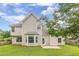 Two story home with a well-manicured lawn, patio, and mature trees at 330 Kentwood Springs Dr, Hampton, GA 30228