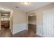 View of the entryway with hardwood floors, wainscoting, and arched doorway at 330 Kentwood Springs Dr, Hampton, GA 30228