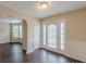 View of the front door with sidelights, hardwood floors, and wainscoting at 330 Kentwood Springs Dr, Hampton, GA 30228