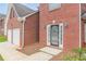 Close up of the red brick facade and front door with decorative glass panels at 330 Kentwood Springs Dr, Hampton, GA 30228