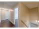 Hallway showing wood floors with a door to one of the bedrooms at 330 Kentwood Springs Dr, Hampton, GA 30228