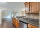 Kitchen with stainless steel appliances, stone countertops, and dark wood cabinets at 330 Kentwood Springs Dr, Hampton, GA 30228
