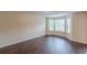 Neutral living room with hardwood floors and bright bay windows at 330 Kentwood Springs Dr, Hampton, GA 30228