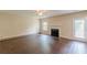 Bright living room with wood floors, a fireplace, and access to the backyard at 330 Kentwood Springs Dr, Hampton, GA 30228