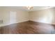 Large living room with wood flooring, a ceiling fan, and neutral paint at 330 Kentwood Springs Dr, Hampton, GA 30228