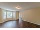 Inviting living room with hardwood floors and natural light from the bay window at 330 Kentwood Springs Dr, Hampton, GA 30228